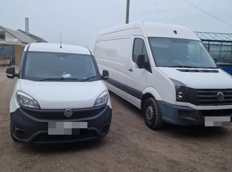 The two Encea Transport vans parked side by side: a white Fiat Doblo and a white VW Crafter long wheelbase